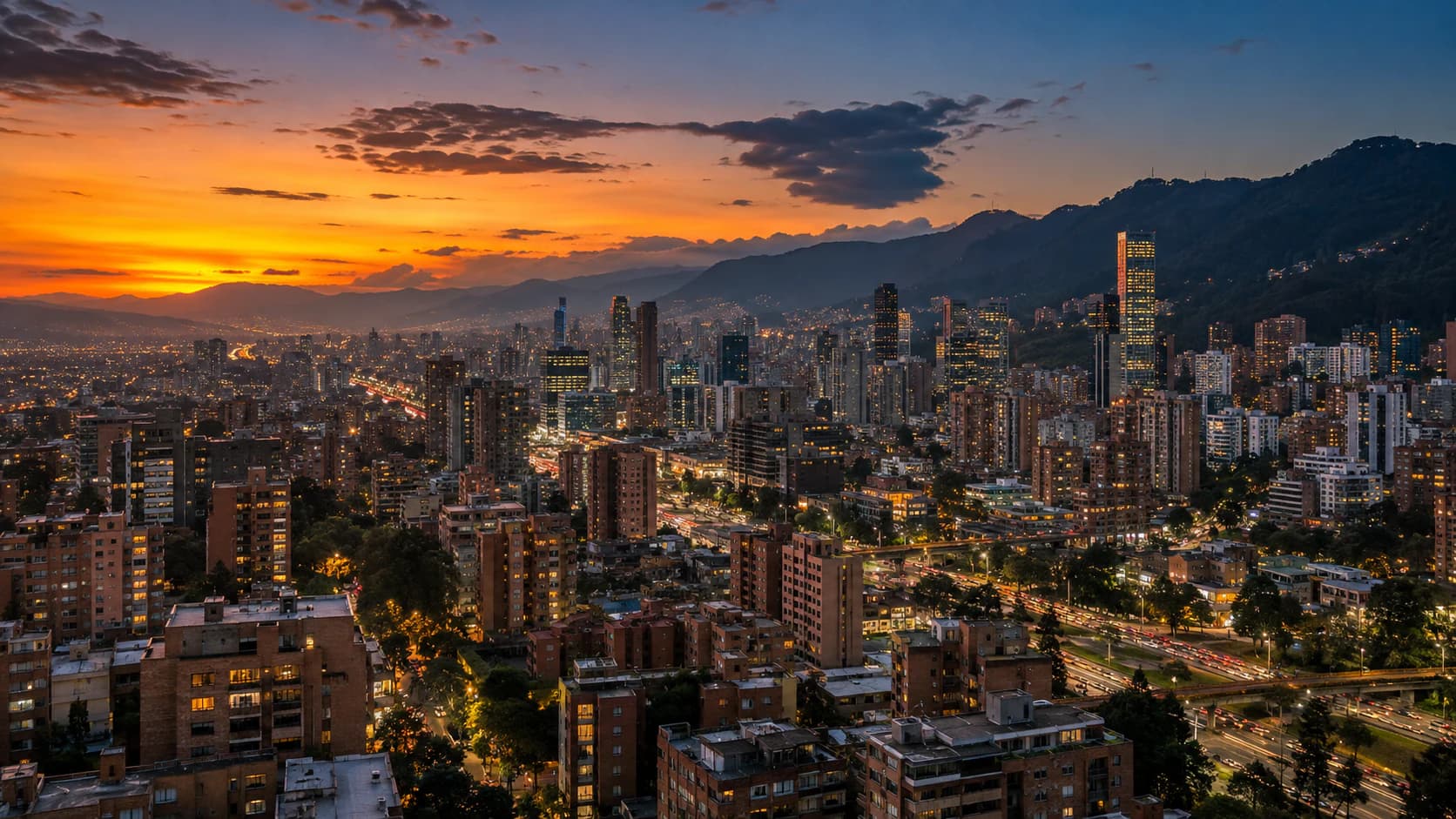 View of an Andean city at sunset with lit buildings and mountains in the background (illustrative image)